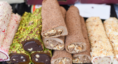 Various types or many colorful assortment of Turkish delights rolls for sale in a shop in Istanbul, or on the street during street food festival. Lokum, a specific Turkey dessert sweets on the marketの写真素材