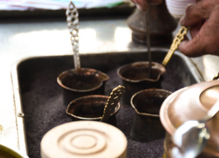 Turkish coffee reparation during street food festival, traditional specialty drink served and prepared on the streets of Turkeyの写真素材