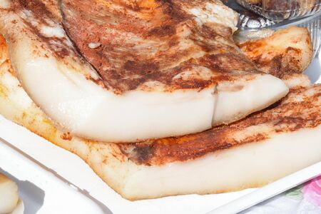 Romanian traditional salty pork belly specialty named slanina, on counter top during farmer market or country fairの写真素材