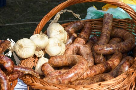 Assorted meat products, sausages, chorizo, spices on a dark table. View from above. Large selection of different dried spicy seasoned beef and pork sausages. Street food, fast food assortment of meatの写真素材