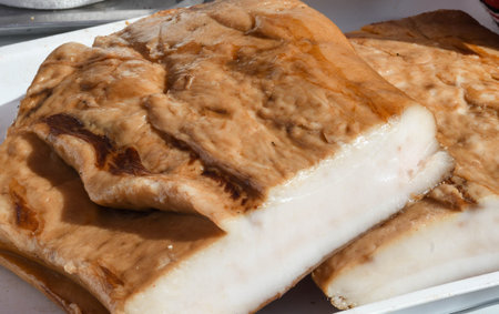 Romanian traditional salty pork belly specialty named slanina, on counter top during farmer market...