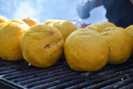 Balls of polenta and cheese in the middle of it, named bulz, a traditional romanian dish. Roasting...