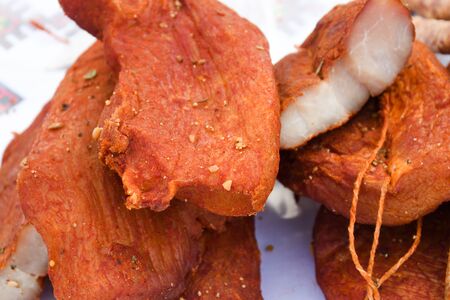 Assorted meat products, sausages, chorizo, spices on a dark table. View from above. Large selection of different dried spicy seasoned beef and pork sausages. Street food, fast food assortment of meatの写真素材