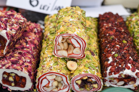 Various types or many colorful assortment of Turkish delights rolls for sale in a shop in Istanbul, or on the street during street food festival. Lokum, a specific Turkey dessert sweets on the marketの写真素材