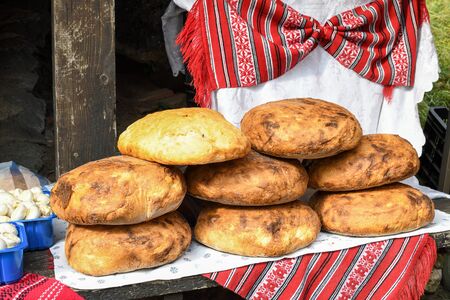 Homemade traditional buns of bread, authentic rustic recipe on counter top during food festival, farmer market in outdoor setting. Bakery or pastry conceptの写真素材