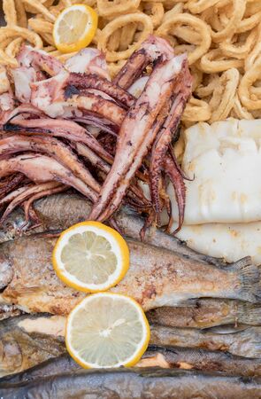 Fresh grilled seafood small baby octopus tentacles during hotel brunch buffet outside outdoor in the garden by the pool. Fresh Food Buffet Brunch Catering Dining Eating Party Sharing Conceptの写真素材