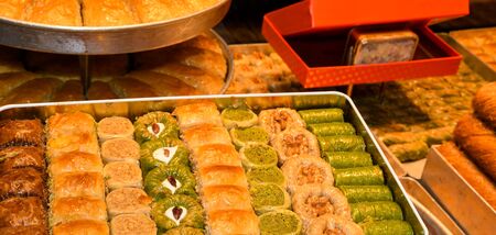 Traditional baklava sweet dessert delights, cataif pastry during hotel brunch buffet outside outdoor in the garden by the pool. Fresh Food Buffet Brunch Catering Dining Eating Party Sharing Conceptの写真素材