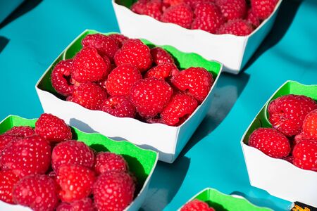 Fresh raspberries for sale at the marketの写真素材