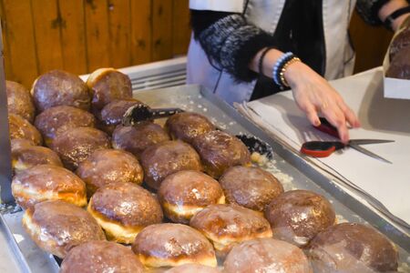 A lot of small round deep fried donuts, simple, no syrup or dipping sauce. Large bowl of donuts isolated, ready to be served during food festival or carnival. Food Buffet Catering Dining Eating Partyの写真素材