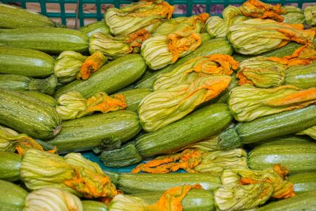 Zucchini with flower for sale at the marketの写真素材