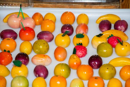 Marzipan is a confection consisting primarily of sugar or honey and almond meal, sometimes augmented with almond oil or extract. Fruit shaped candy, traditional sicilianの写真素材