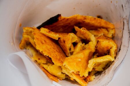 Big Plate of Farinata or Cecina or Torta di ceci thin unleavened pancake or crepe of chickpea flour originating in Genoa cooked in a wood oven, socca for saleの写真素材