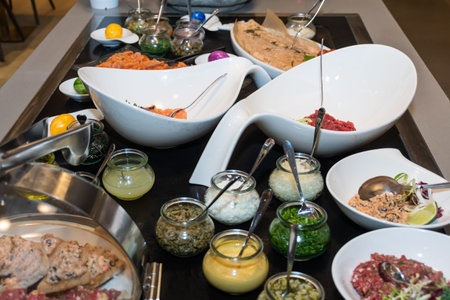 Tartar raw meat and fish brunch buffet easter bar table, in a hotel setting or a rastaurant during a...