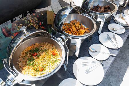 Live food stations. Kitchenware in the line catering summer brunch buffet food luxury hotel outdoor outside garden by the pool al fresco restaurant.Corporate cocktail event party warm food stations.の写真素材