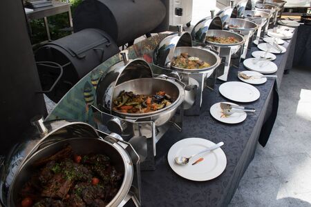 Live food stations. Kitchenware in the line catering summer brunch buffet food luxury hotel outdoor outside garden by the pool al fresco restaurant.Corporate cocktail event party warm food stations.の写真素材