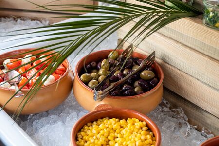 Luxury catering by the pool, food bloggers event, banquet, wedding, festive, hotel brunch buffet arrangement with clean simple design, decorations, boat filled with ice. Modern design and decorationsの写真素材