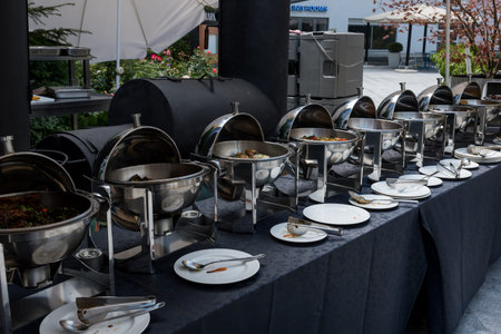 Live food stations. Kitchenware in the line catering summer brunch buffet food luxury hotel outdoor outside garden by the pool al fresco restaurant.Corporate cocktail event party warm food stations.の写真素材