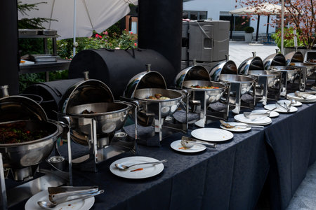 Live food stations. Kitchenware in the line catering summer brunch buffet food luxury hotel outdoor outside garden by the pool al fresco restaurant.Corporate cocktail event party warm food stations.の写真素材