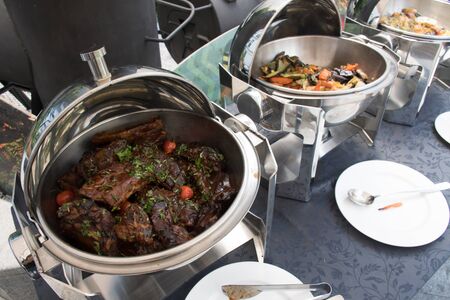 Live food stations. Kitchenware in the line catering summer brunch buffet food luxury hotel outdoor outside garden by the pool al fresco restaurant.Corporate cocktail event party warm food stations.の写真素材