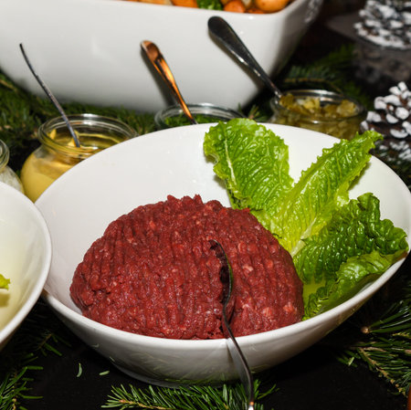 Beef tartar with various sauces dressings during hotel brunch buffet outside outdoor in the garden by the pool. Fresh Food Buffet Brunch Catering Dining Eating Party Sharing Conceptの写真素材