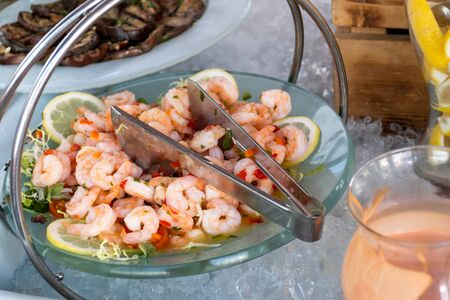 Luxury catering by the pool, food bloggers event, banquet, wedding, festive, hotel brunch buffet arrangement with clean simple design, decorations, boat filled with ice. Modern design and decorationsの写真素材