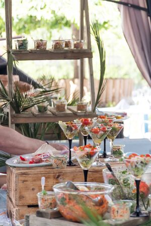 Luxury catering by the pool, food bloggers event, banquet, wedding, festive, hotel brunch buffet arrangement with clean simple design, decorations, boat filled with ice. Modern design and decorationsの写真素材