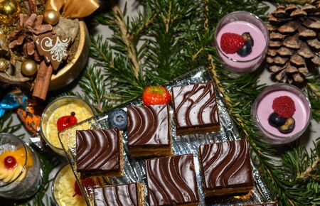 Various desserts in candy bar food buffet during hotel brunch, catering, food bloggers event, banquet, wedding, festive sweet dessert celebration party concept. Cake pops, mousse, tarts, puddingsの写真素材