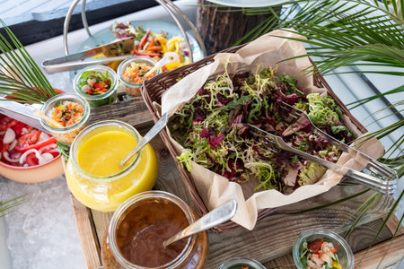 Luxury catering by the pool, food bloggers event, banquet, wedding, festive, hotel brunch buffet arrangement with clean simple design, decorations, boat filled with ice. Modern design and decorationsの写真素材