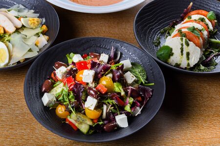 Greek salad or horiatiki salad is a salad in Greek cuisine. Greek salad is made with pieces of tomatoes, sliced cucumbers, onion, feta cheese, and olives, typically seasoned with salt and Greek mountaの写真素材