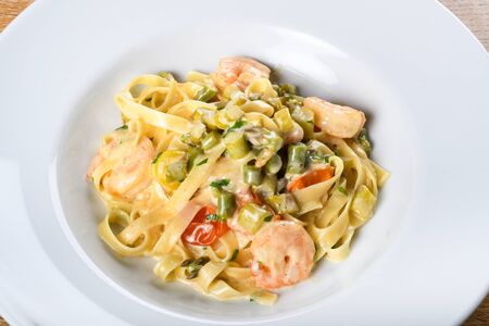 Italian tagliatelle with asparagus and shrimps or scampi, dill cream sauce. Fresh Food Dining Eating Conceptの写真素材