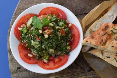 Tabbouleh salad. Traditional middle eastern or arab dish. Levantine vegetarian salad with parsley, mint, bulgur, tomato.の写真素材
