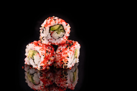Simple sushi nigiri maki set isolated on black background. Various selection of traditional japanese food. Fresh rice seafood asian cuisine specialty with copy space.Chopsticks, nobody, sushi platterの写真素材