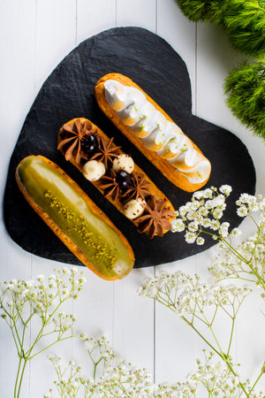 Eclairs pastry made with choux dough filled with cream and topping. Elegant, luxurious, expensive...