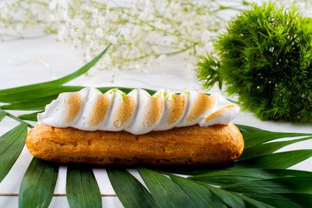 Eclairs pastry made with choux dough filled with cream and topping. Elegant, luxurious, expensive confectionery concept. Fresh Food Buffet Brunch Catering Dining Eating Party Sharing Conceptの写真素材