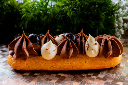 Eclairs pastry made with choux dough filled with cream and topping. Elegant, luxurious, expensive...