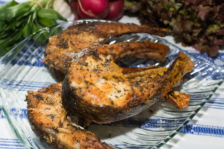 Freshly grilled fish on kitchen table. closeup and top view.