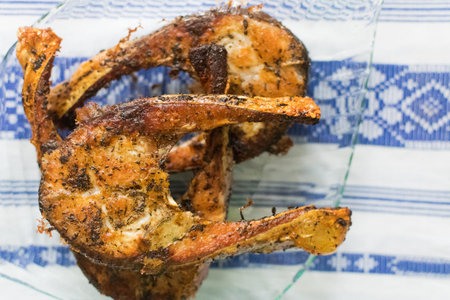 Freshly grilled fish on kitchen table. closeup and top view.