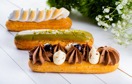 Eclairs pastry made with choux dough filled with cream and topping. Elegant, luxurious, expensive...