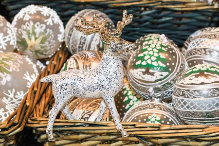 Christmas decorations on the market in Vienna. For sale on Christmas fair in Western Europe, Vienna, Austria. Golden balls, bulbs, bubbles, decorations and ornaments, colored shiny magic fairy taleの写真素材