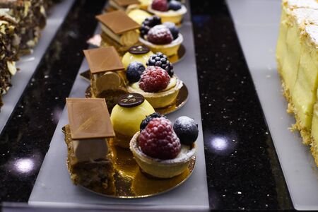 Various types of cakes, tart, mousse, pies for sale in bakery or pastry shop, gourmet luxury concept for candy bar. Happy birthday many slices of dessert specialties, luxury gourmet and elegant recipeの写真素材