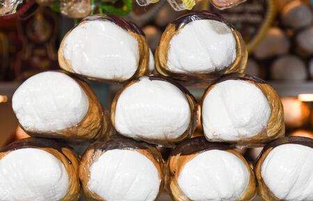 Schaumrollen, or Schillerlocken, are an Austrian confection. They consist of a cone or tube of pastry, often filled with whipped cream or meringue. foam rollers, a bag or roll-shaped puff pastryの写真素材