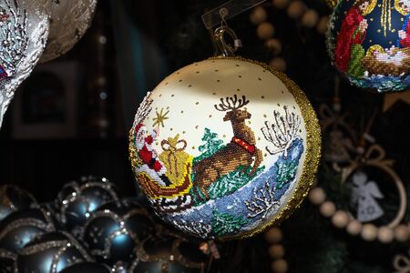 Christmas decorations on the market in Vienna. For sale on Christmas fair in Western Europe, Vienna, Austria. Golden balls, bulbs, bubbles, decorations and ornaments, colored shiny magic fairy taleの写真素材