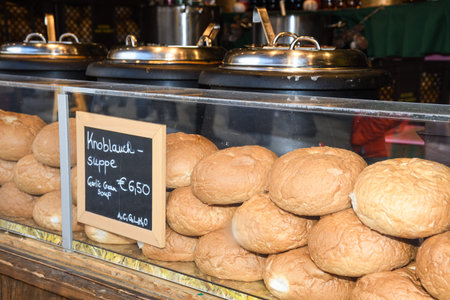 Variety of delicious breads displayed on shelves in bakery. Freshly baked bread at the farmer's...