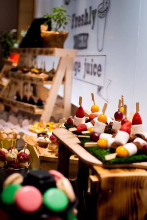 Candy bar food buffet by the pool, during hotel brunch, catering in the garden, food bloggers event, banquet, wedding, festive sweet dessert celebration party, mousse, cherry tart, fruit cupcakesの写真素材