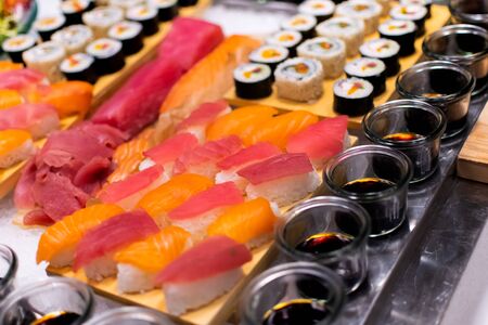 Sushi selection platter with maki, nigiri, rolls during hotel brunch buffet outside outdoor in the garden by the pool.の写真素材