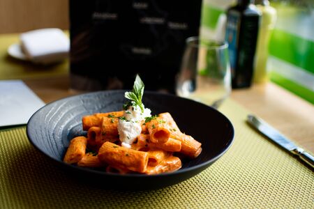 Cannelloni are a cylindrical type of lasagna generally served baked with a filling and covered by a sauce in Italian cuisineの写真素材