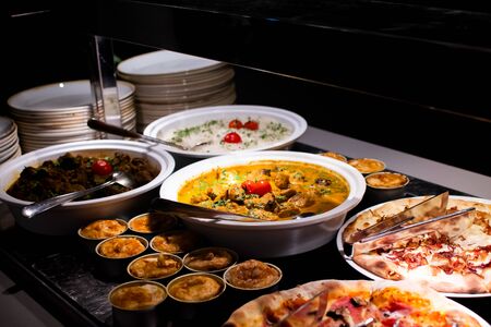 Sunday Brunch Menu with salads, meat, cheese cuts and vegetables during hotel brunch buffet indoor restaurant setting.の写真素材
