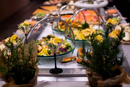 Shrimp cocktail, tabbouleh and carrot salad vegetables during hotel brunch buffet outside outdoor in the garden by the pool. Fresh Food Buffet Brunch Catering Dining Eating Party Sharing Conceptの写真素材