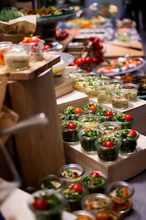 Sunday Brunch Menu with salads, meat, cheese cuts and vegetables during hotel brunch buffet indoor restaurant setting.の写真素材