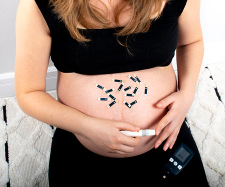 Pregnant woman verifing glycemic index with device for gestational diabetes in pregnancy. sugar free diet and healthy eating concept lifestyle for normal glycemic levelsの写真素材